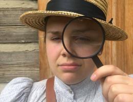 A woman looking through a magnifying glass